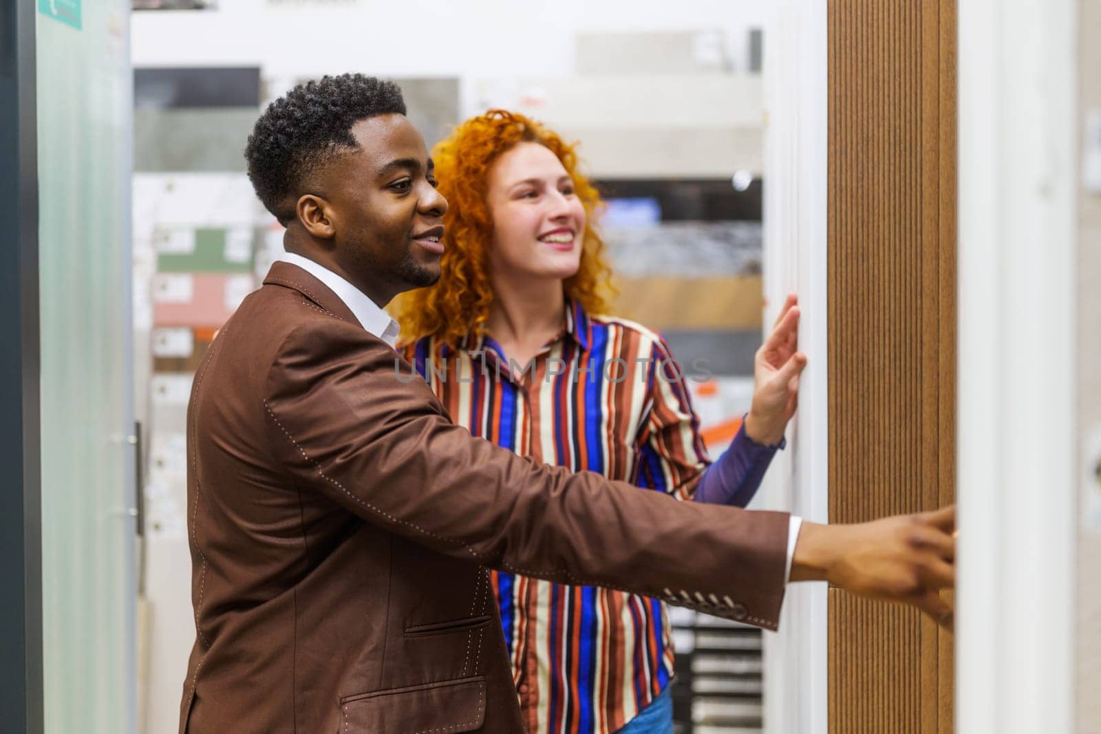 Happy couple choosing tiles for their apartment.