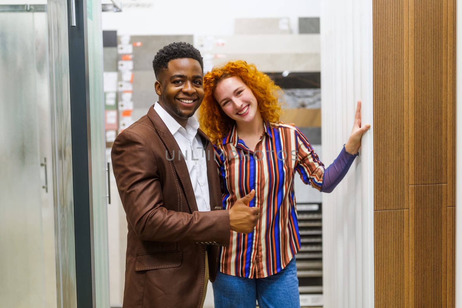 Portrait of young couple who owns small business bath store by djoronimo