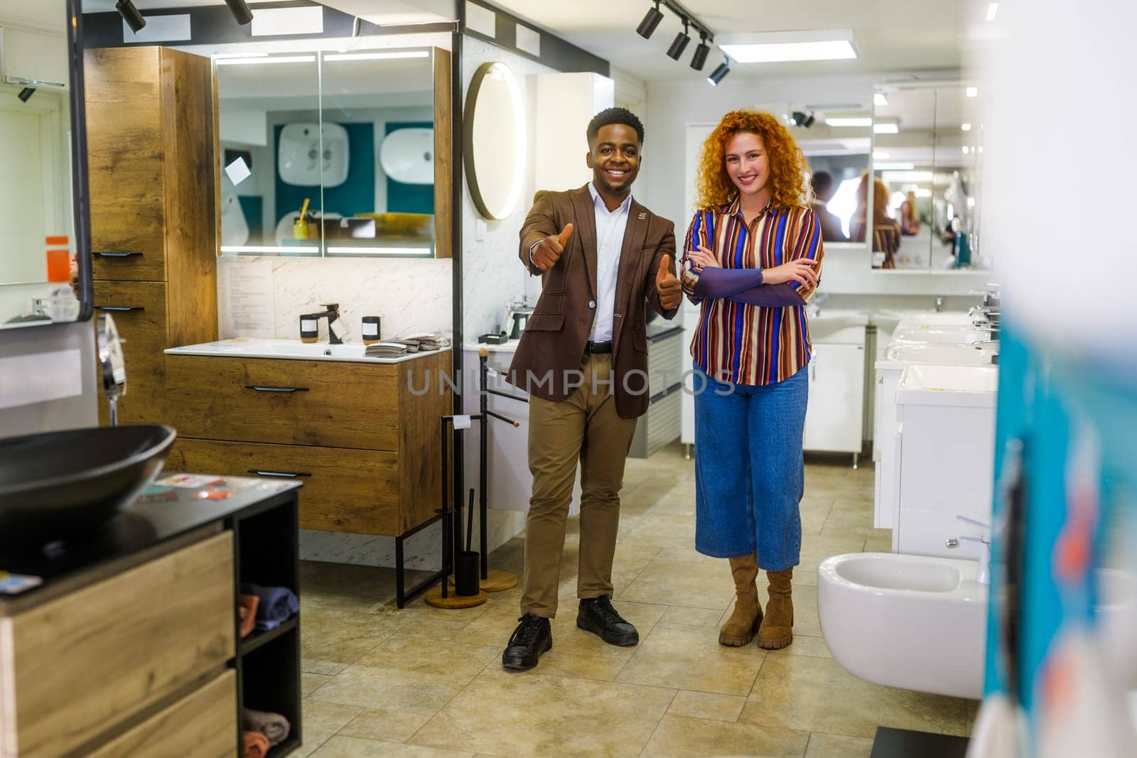 Portrait of young couple who owns small business bath store by djoronimo