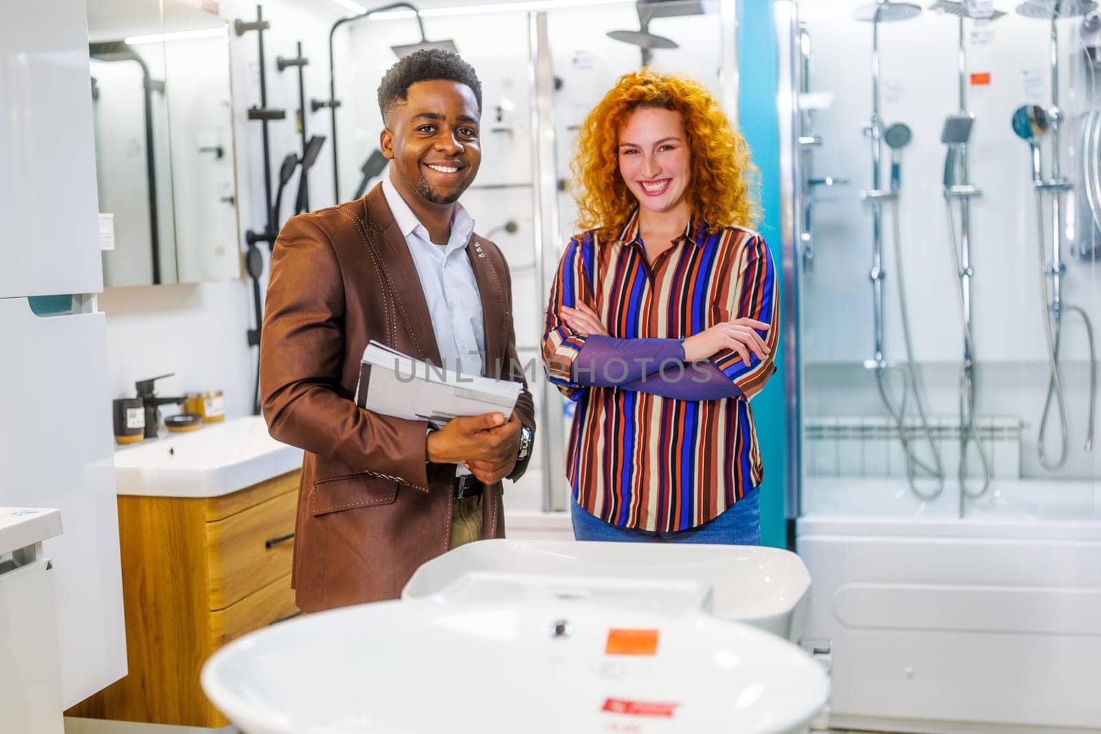 Portrait of young couple who owns small business bath store. Man and woman work in partnership.