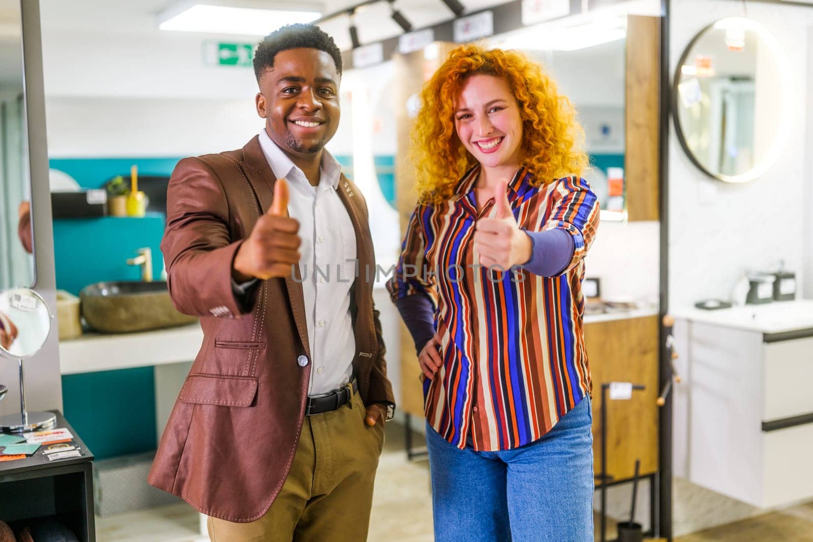 Portrait of young couple who owns small business bath store by djoronimo