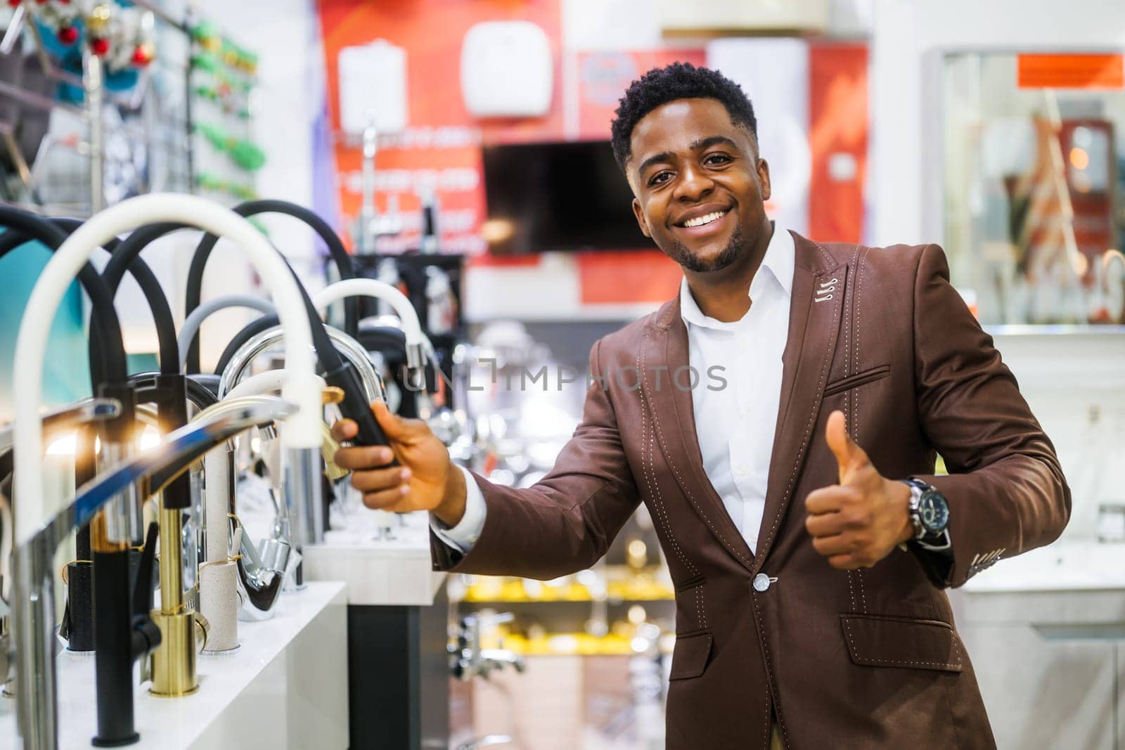 Portrait of buyer in bathroom store. Man is choosing faucet for his apartment.