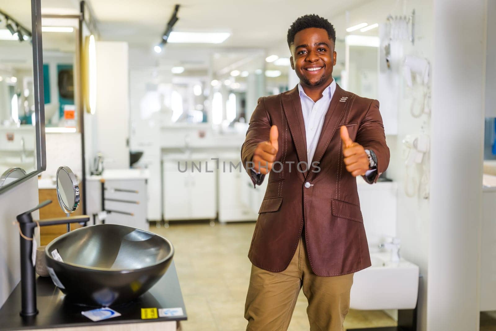 Portrait of salesperson in bathroom store. Happy man works in bath store. Sales occupation.