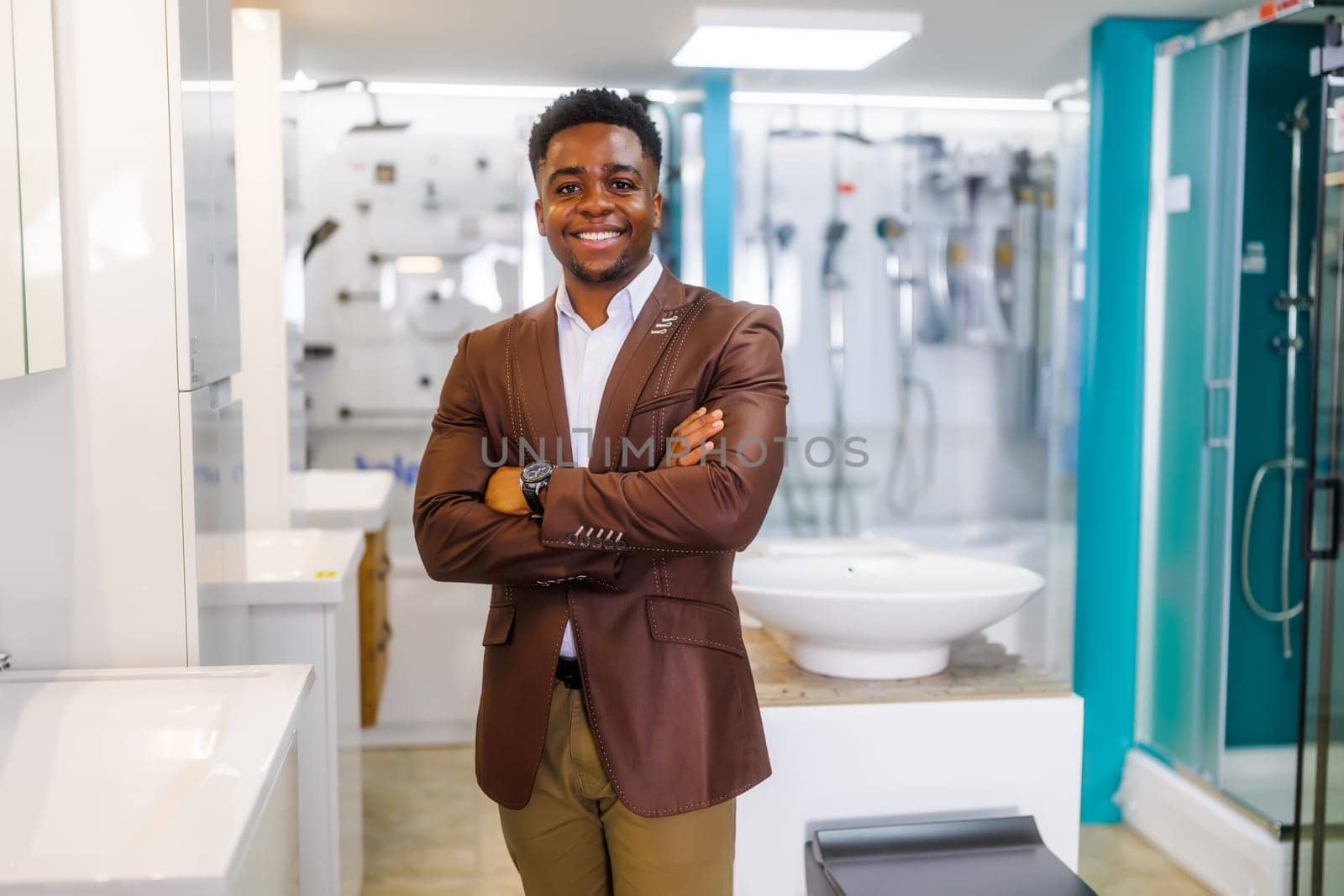 Portrait of salesperson in bathroom store. Happy man works in bath store. Sales occupation.