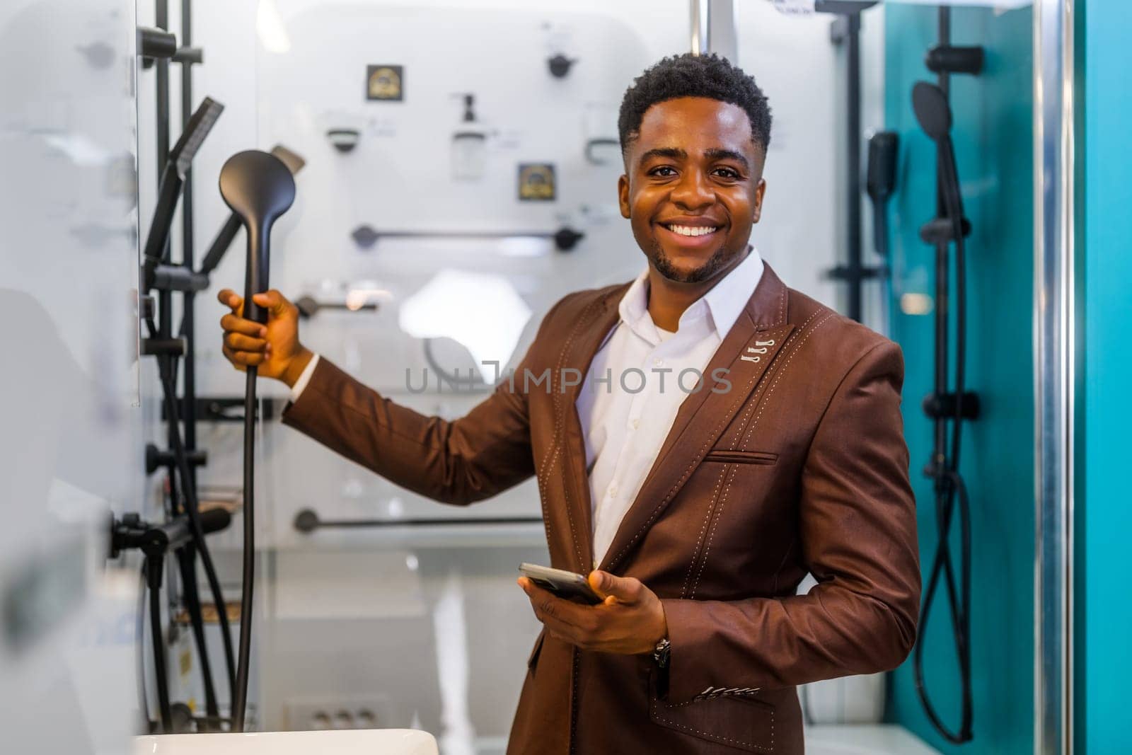 Portrait of buyer in bathroom store. Man is choosing bathtub for his apartment.