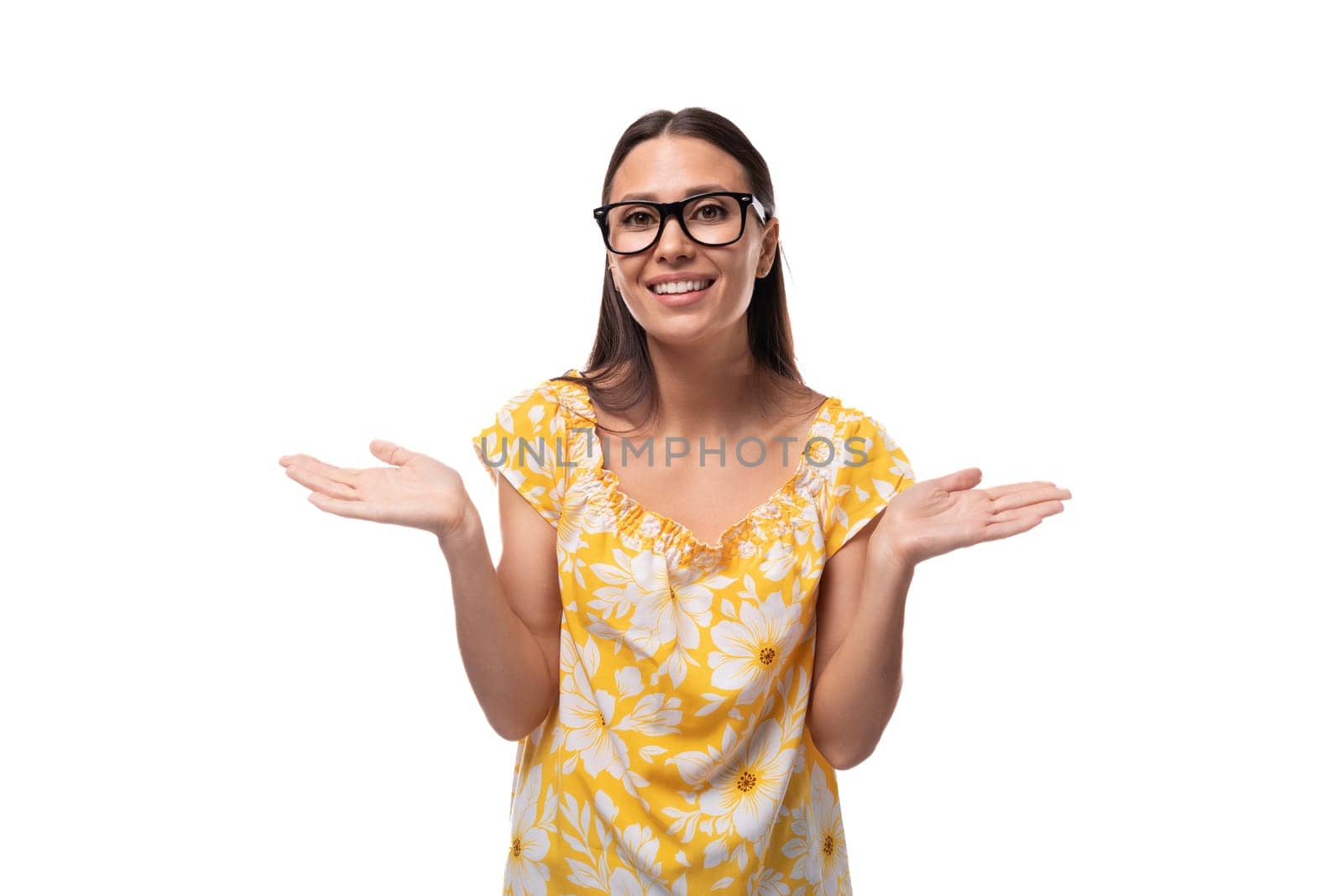 a young woman dressed in a yellow sundress wears glasses for vision correction.