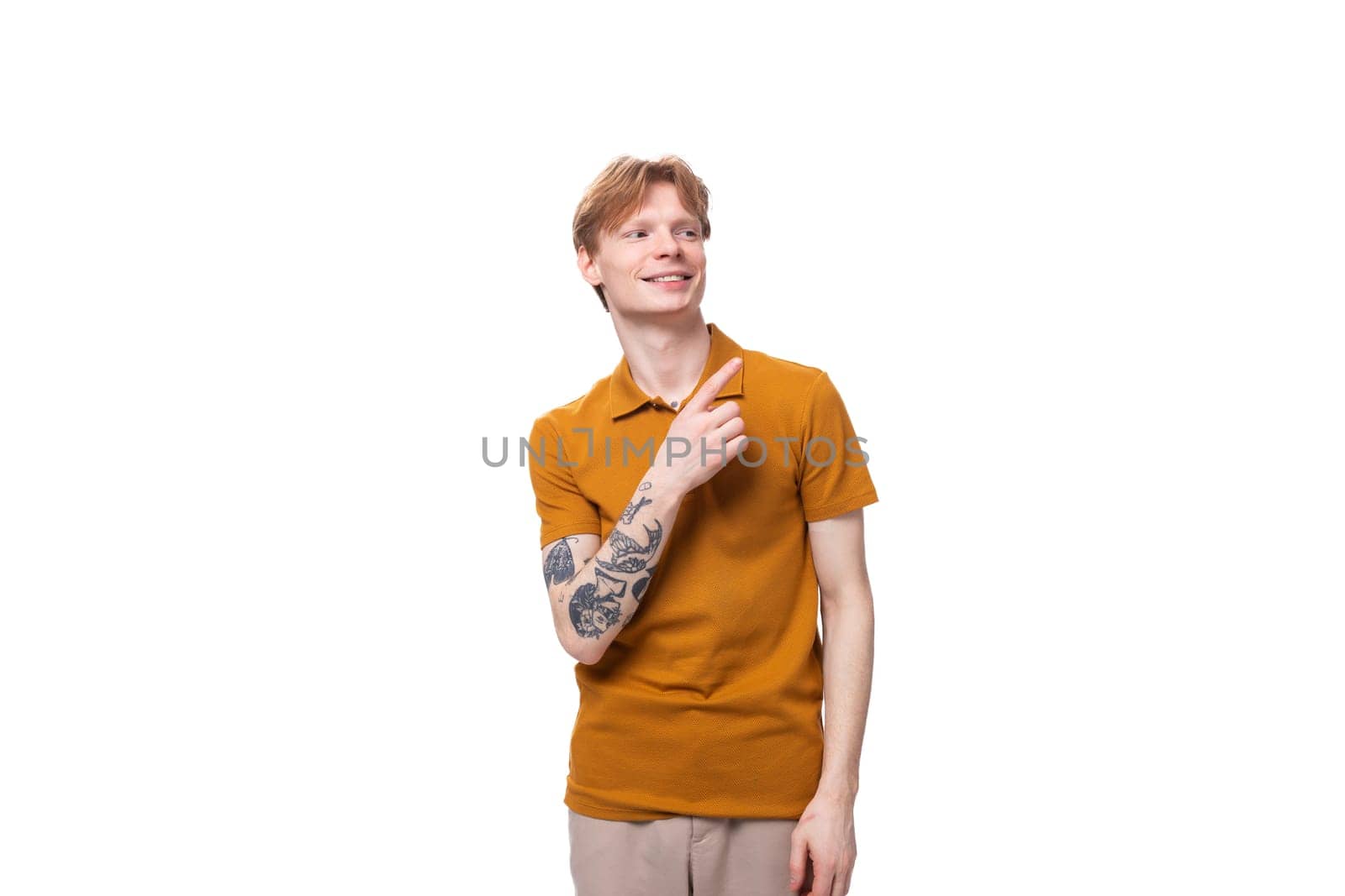 a young handsome red-haired man with a haircut and a tattoo on his arm tells the news. advertising concept by TRMK
