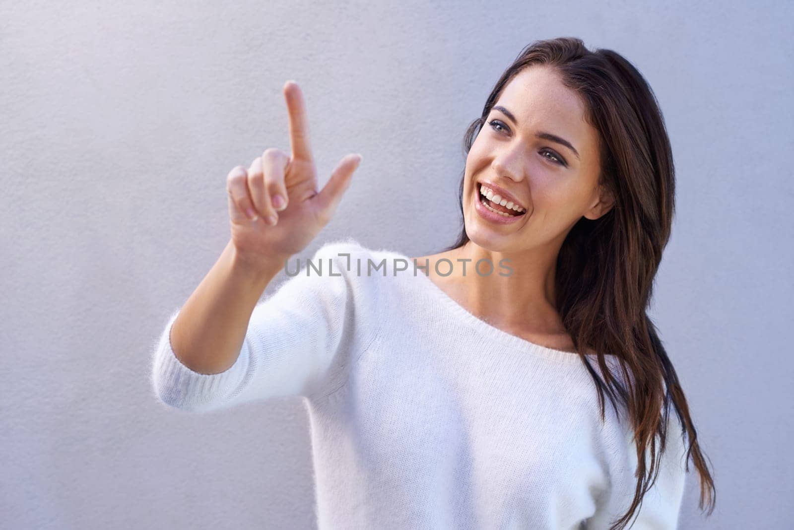 Fashion, pointing and woman with smile for sweater with warm, texture and casual for winter. Studio background, female person with happiness, joy and girl with jersey of wool for comfort in New York.