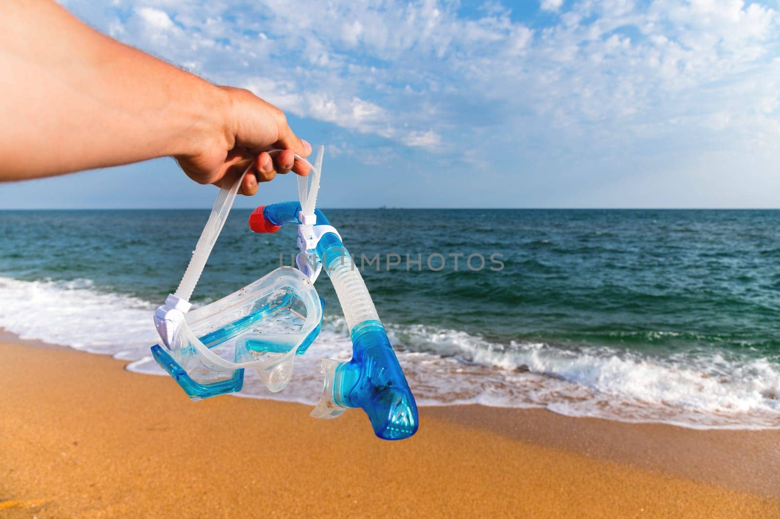 Underwater mask for snorkeling against the backdrop of sunset sandy shore and sea by yanik88