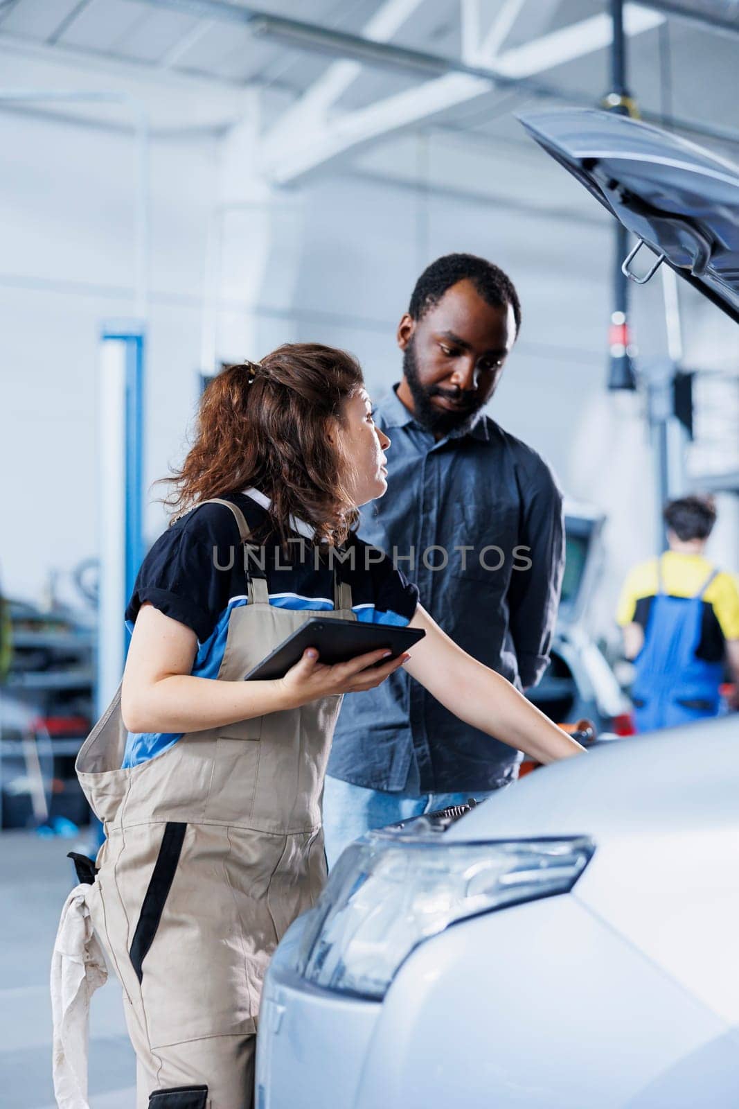 Employee in car service orders new part by DCStudio