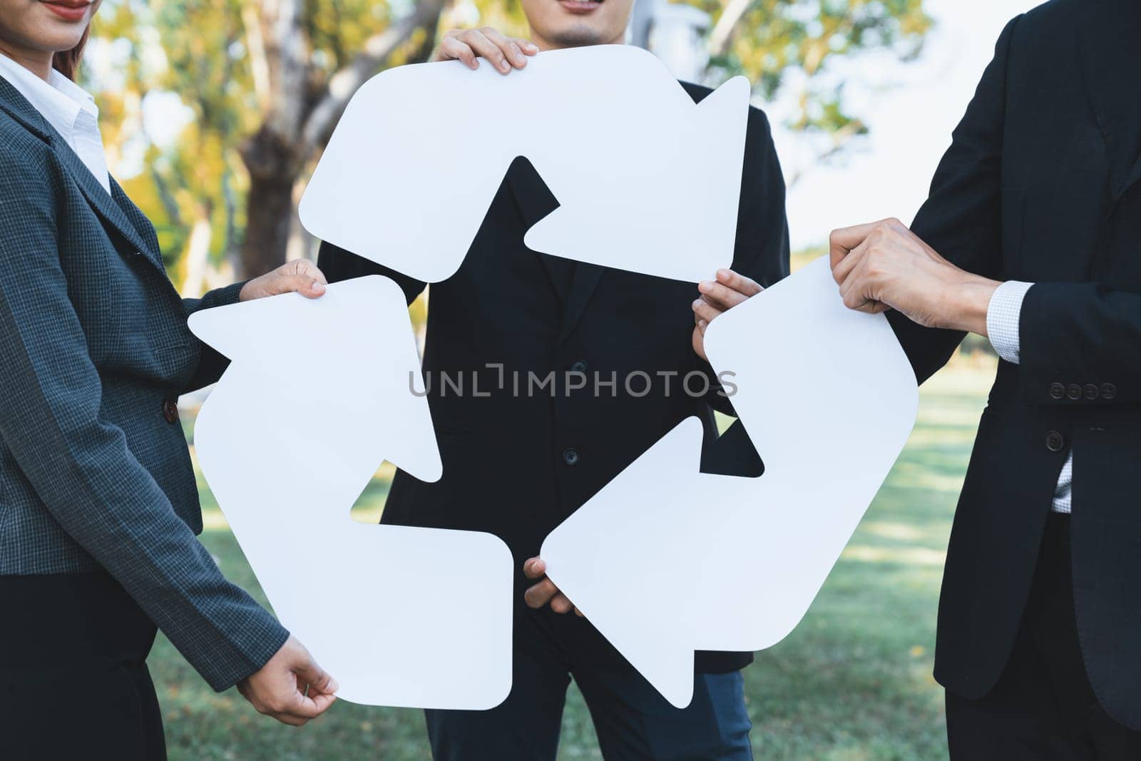 Business people holding pieces of reverse arrow icon into recycle symbol. Gyre by biancoblue