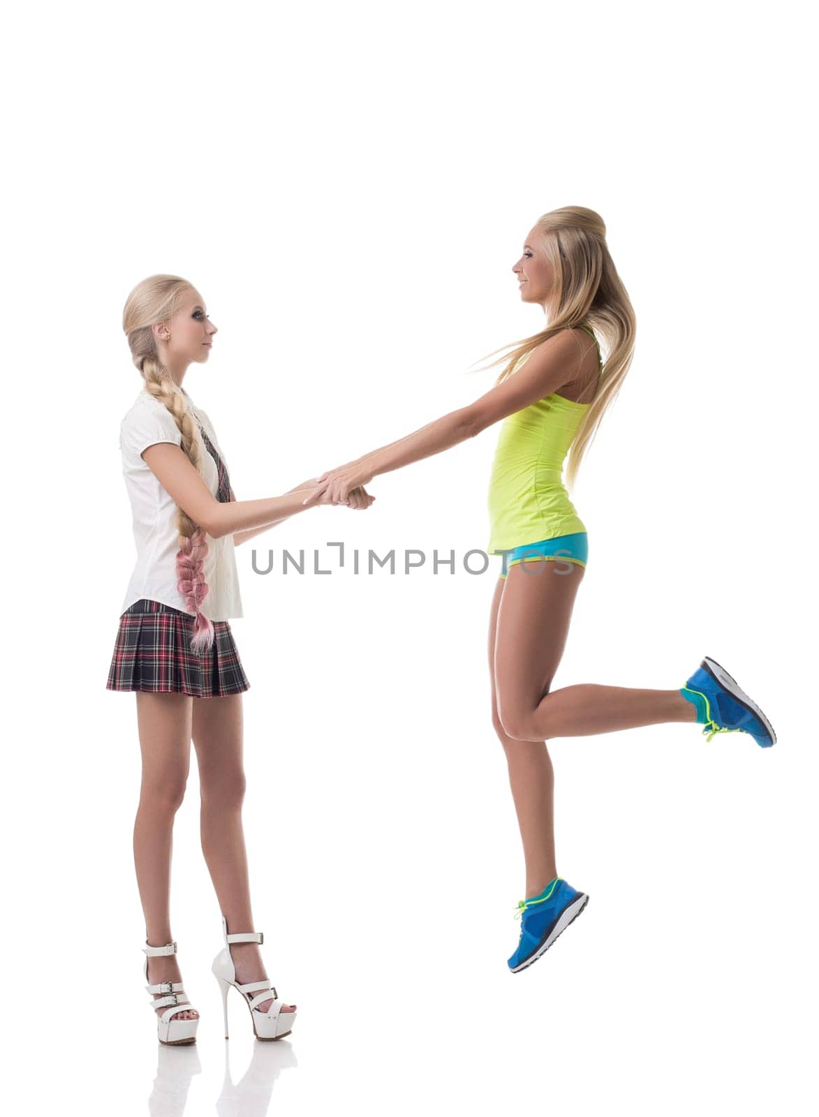 Sport or study. Girl holds hand of friend jumping by rivertime