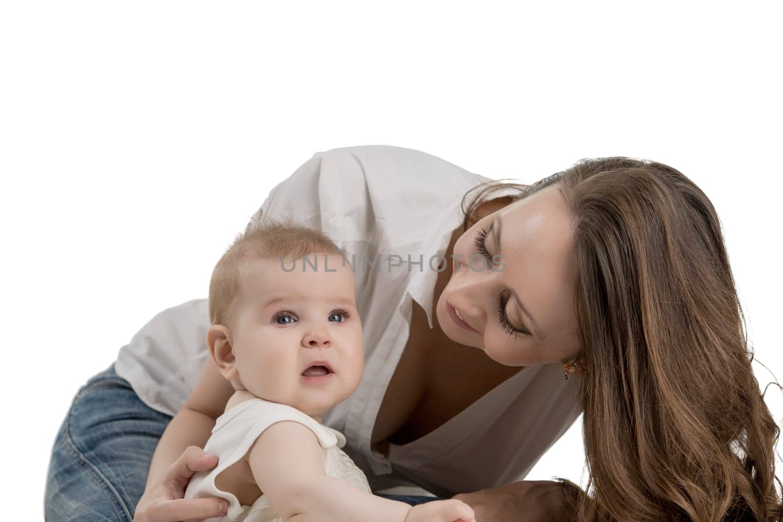 Smiling mother looking at her adorable little daughter