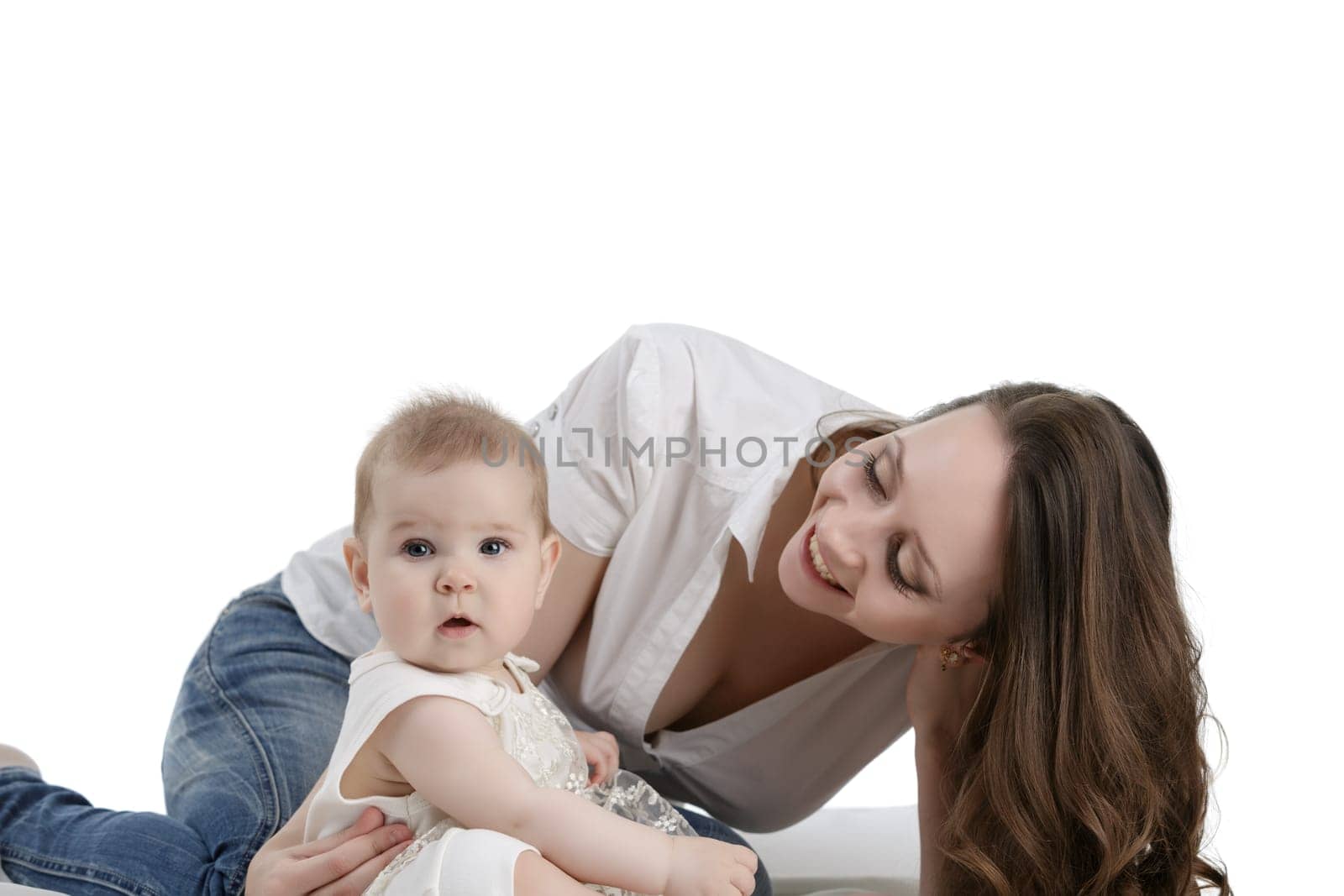 Happy dark-haired mother playing with her lovely baby