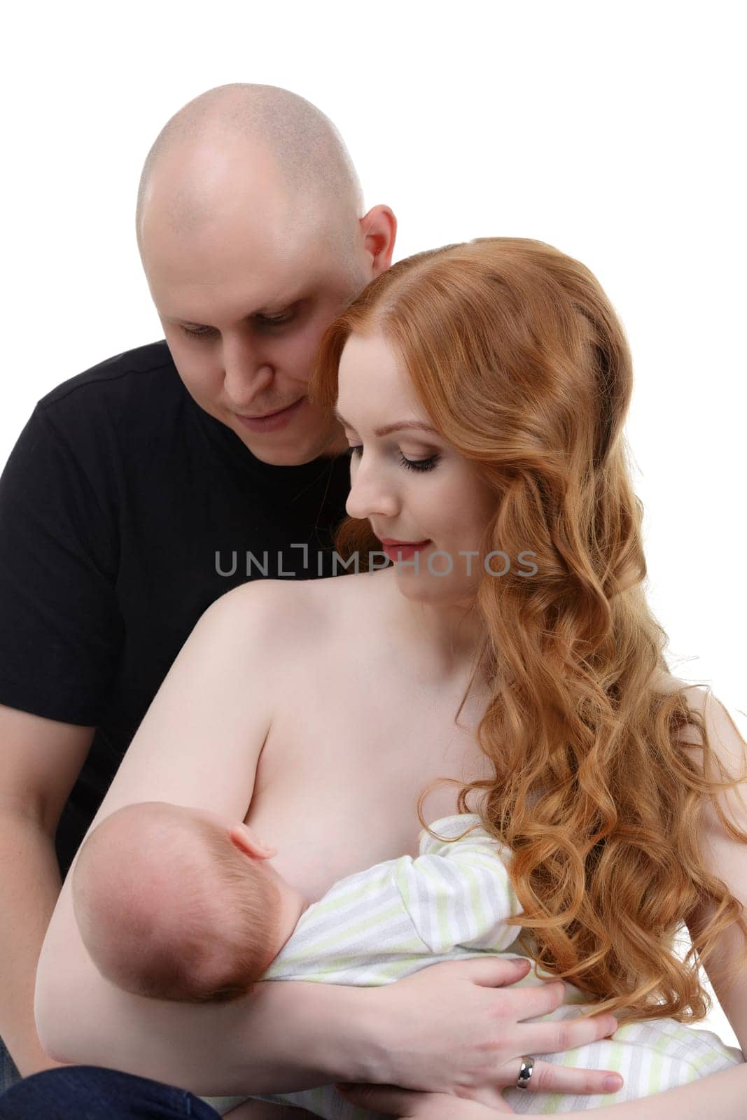 Studio portrait of happy parents and their little son