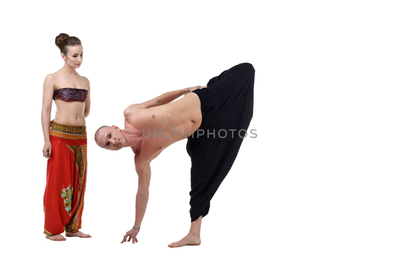 Woman watches as yoga instructor performs asana by rivertime
