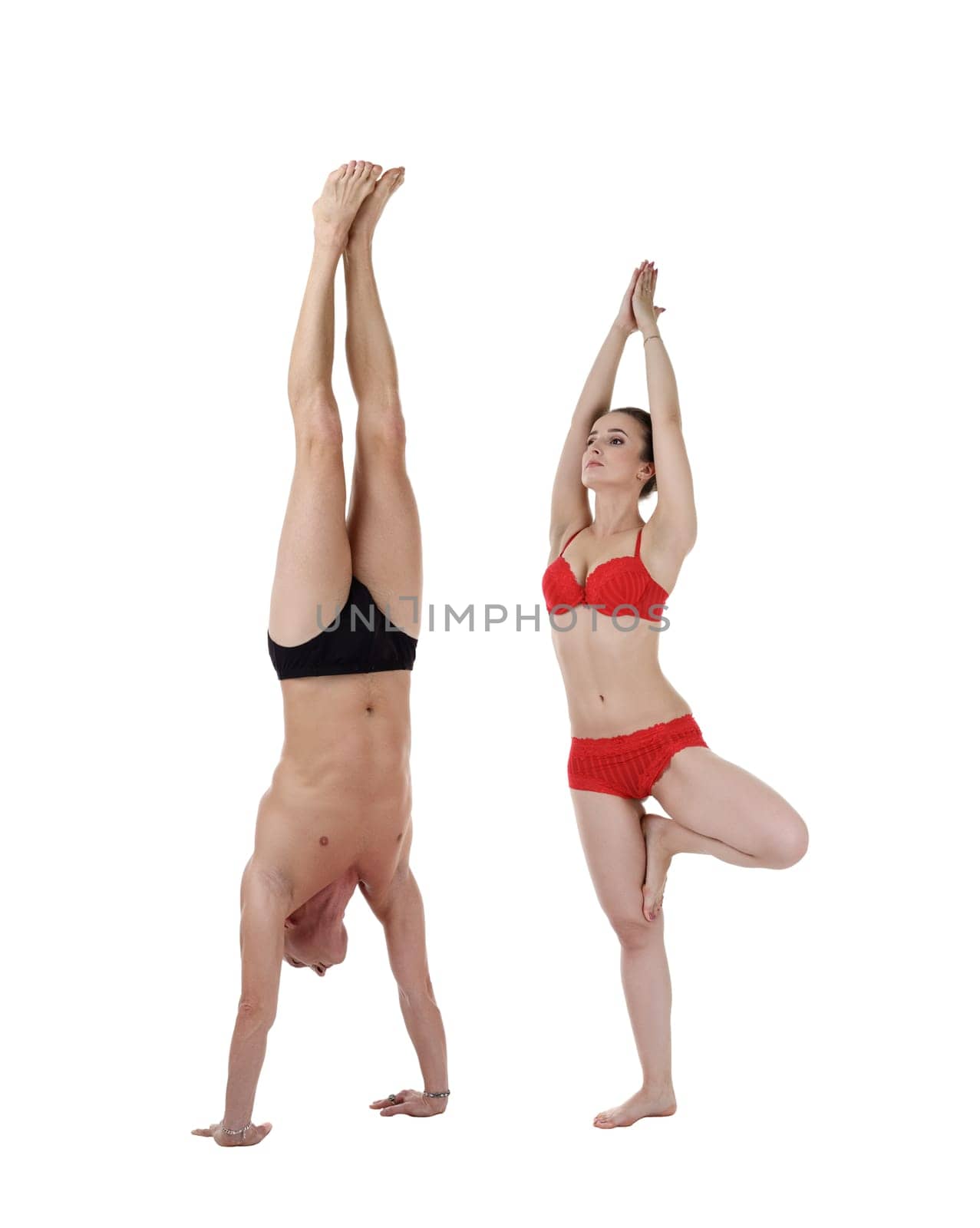 Man doing handstand and woman stand on one leg by rivertime