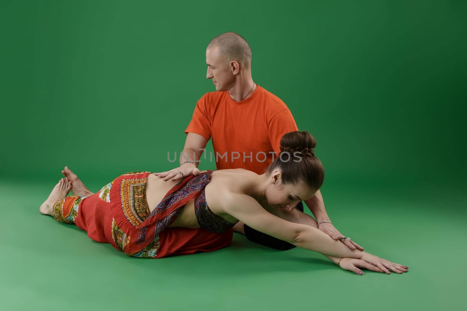 Yoga. Woman doing asana and instructor watching at her