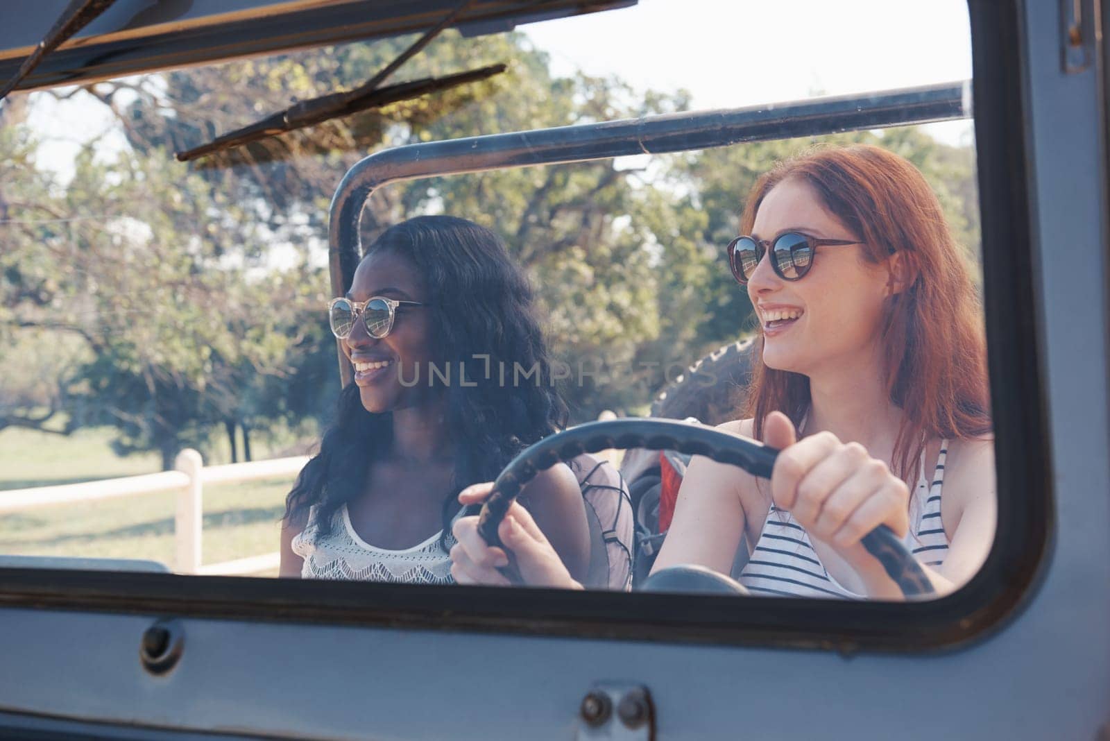 Happy women, diversity and travel on road trip in countryside and sightseeing for adventure in nature. Friends, driving and transportation in convertible suv on holiday and bonding together in texas by YuriArcurs