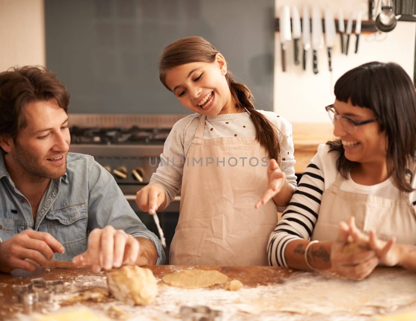 Mother, father and child with baking dough in kitchen with flour, happiness and teaching with support. Family, parents and girl with helping, learning and bonding with cooking for hobby and playing by YuriArcurs