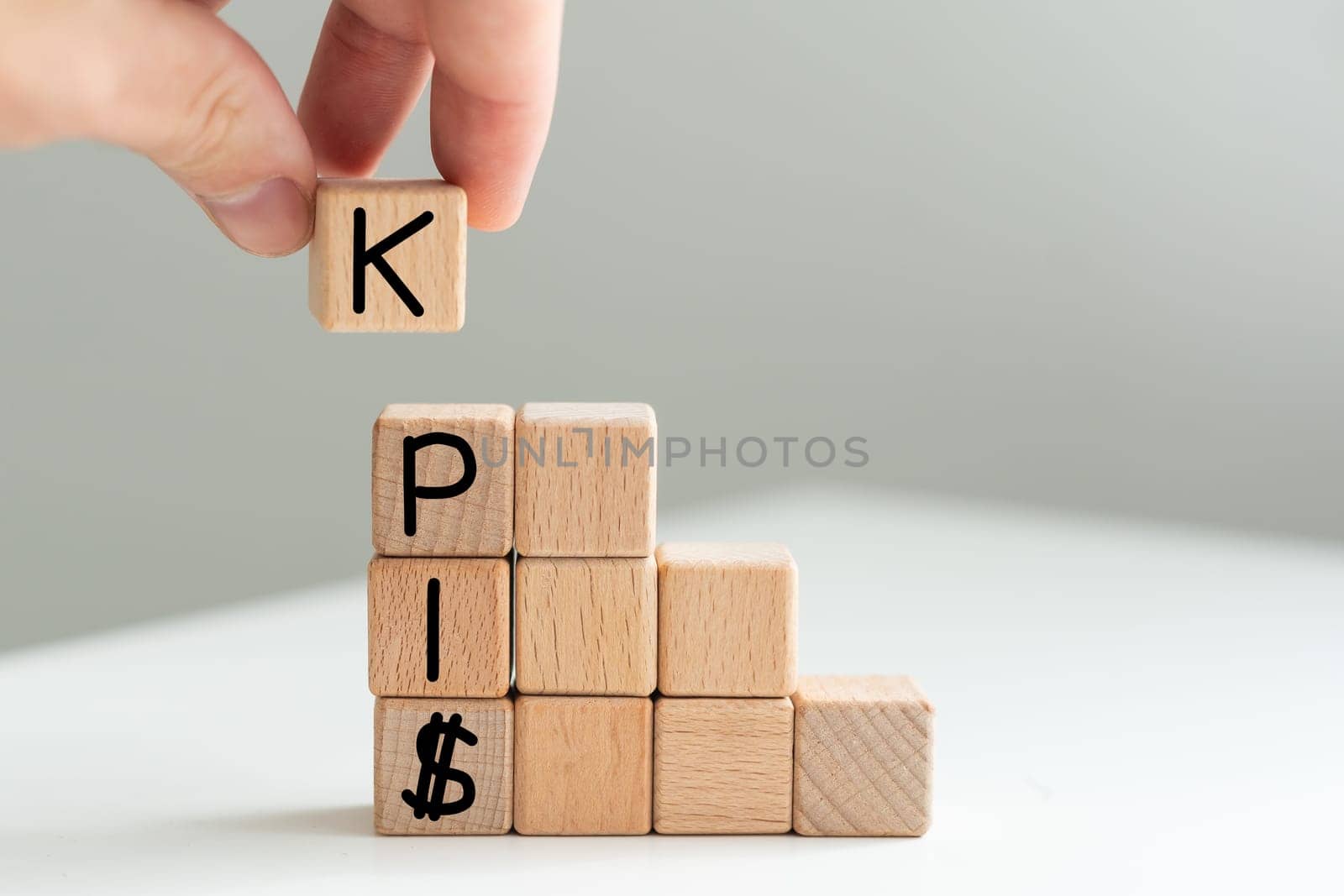 KPI, key performance indicator symbol. Concept word KPI, key performance indicator on wooden circles on beautiful white background, copy space. Business, KPI, key performance indicator concept. High quality photo