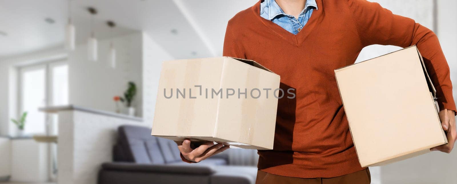 man moving to a new home with box by Andelov13