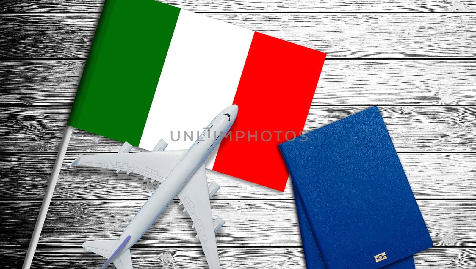 Toy airplane placed on the national flag of Italy. High quality photo
