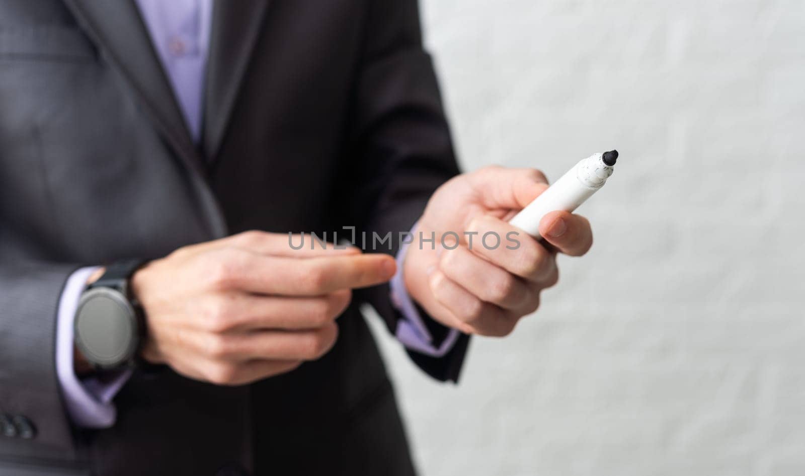 Hand writing with a white felt-tip pen on white background. High quality photo