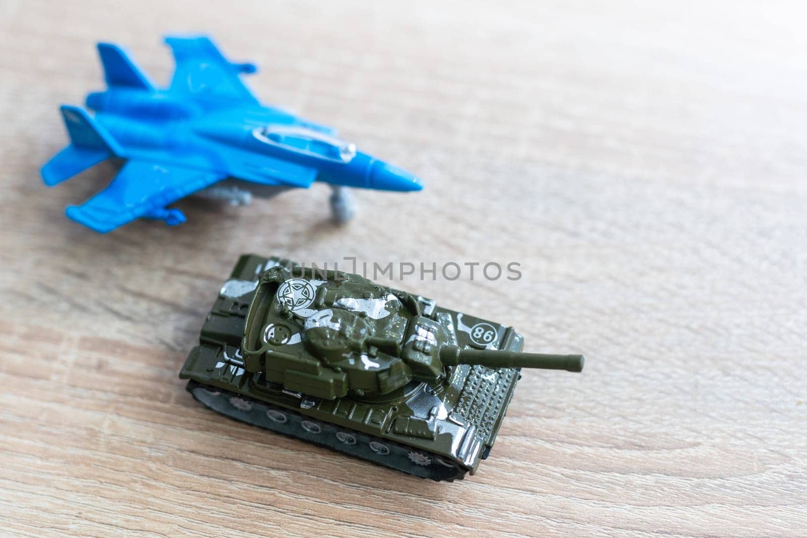 The image shows models of tanks and fighter jets on a white background, close up. by Andelov13