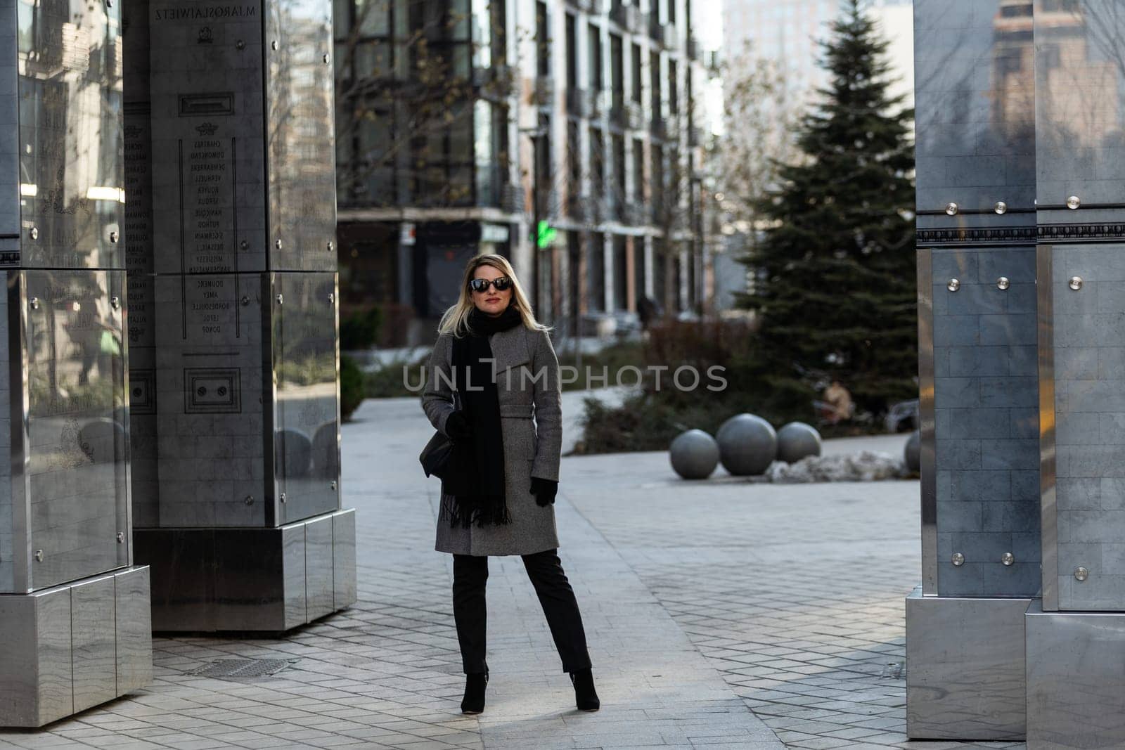 A young girl blonde walks through the city. High quality photo