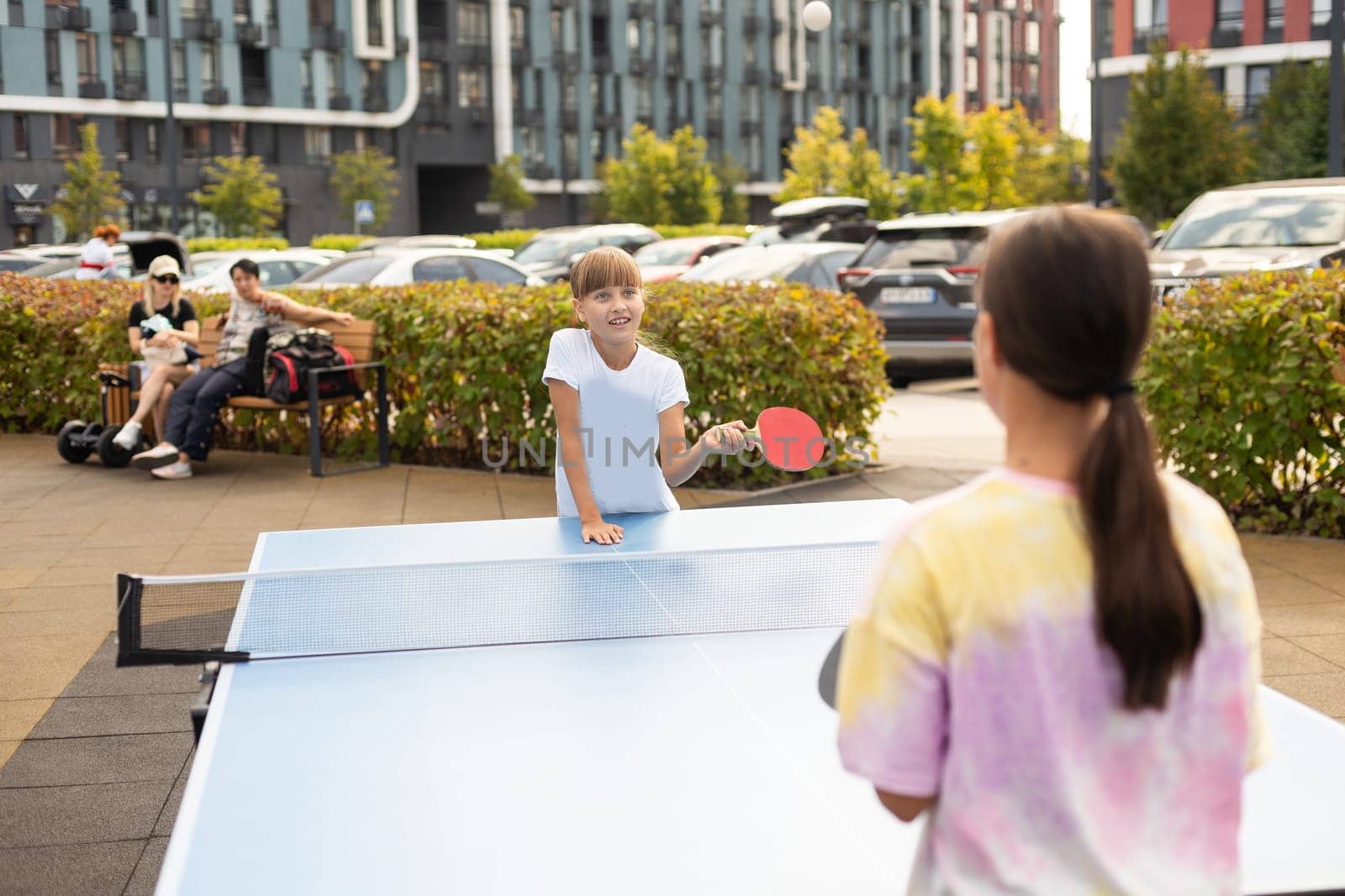 girl plays in table tennis outdoor. High quality photo