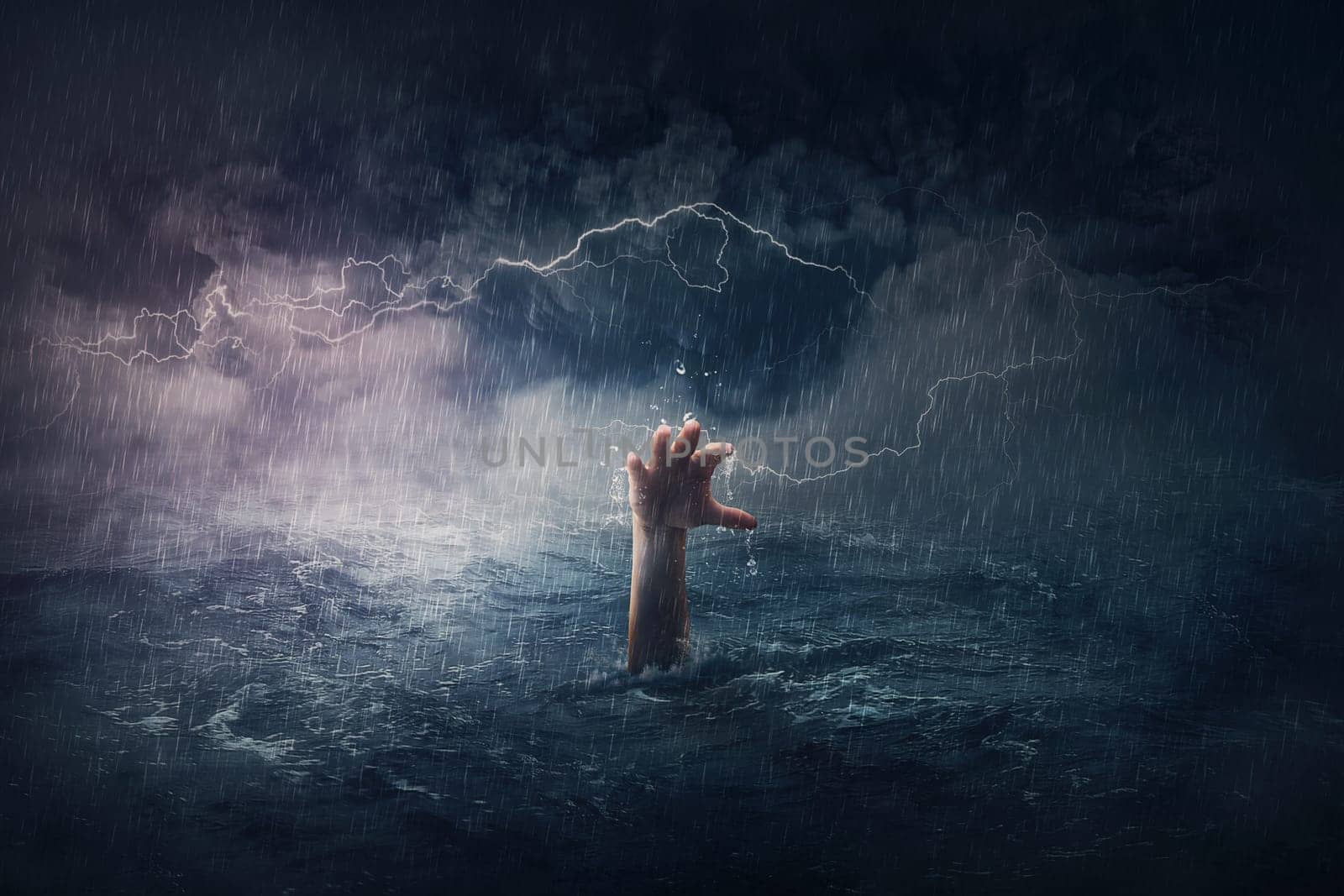 Arm drowning in the sea. Surreal and dramatic scene of person hand sinking in the ocean under a hurricane stormy weather. People need help in risk situations. Despair, depression and failure metaphor by psychoshadow