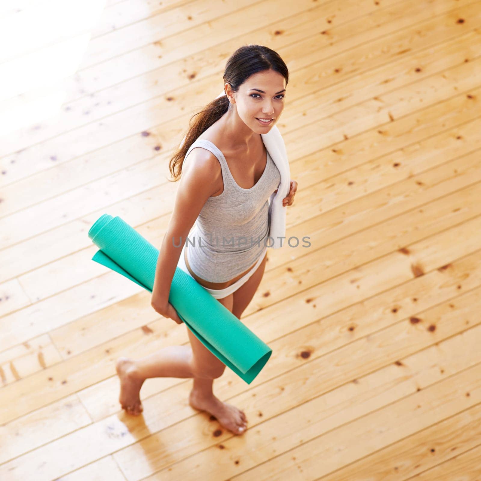 Woman, portrait and mat ready for yoga or wellness, health and meditation for spiritual awareness. Female person, pilates and exercise or fitness in living room, zen and mindfulness on mockup space by YuriArcurs