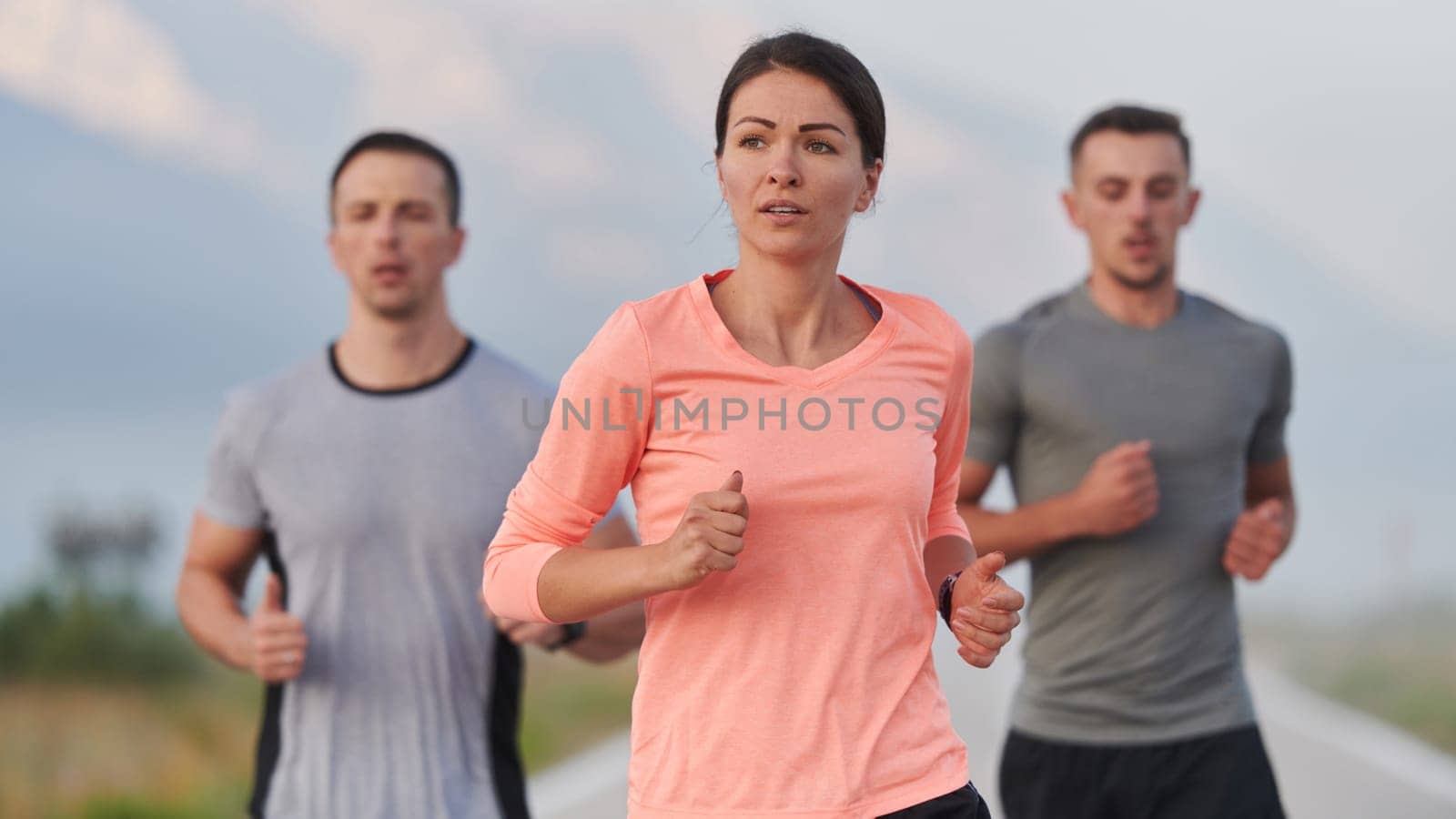 A group of friends, athletes, and joggers embrace the early morning hours as they run through the misty dawn, energized by the rising sun and surrounded by the tranquil beauty of nature by dotshock