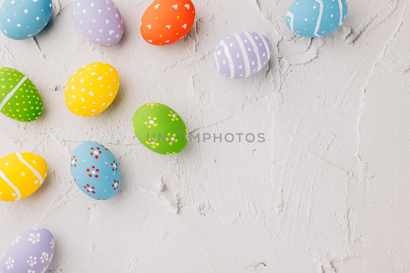 Easter Day Concept. Top view holiday banner background web design white colorful easter eggs painted on white cement background with empty copy space, celebration greeting card, overhead, template