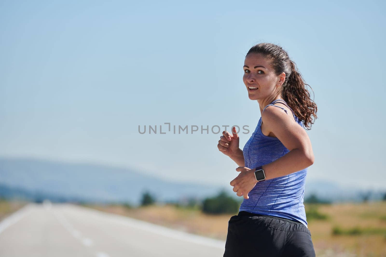 A determined woman athlete trains for success in the morning sun. by dotshock