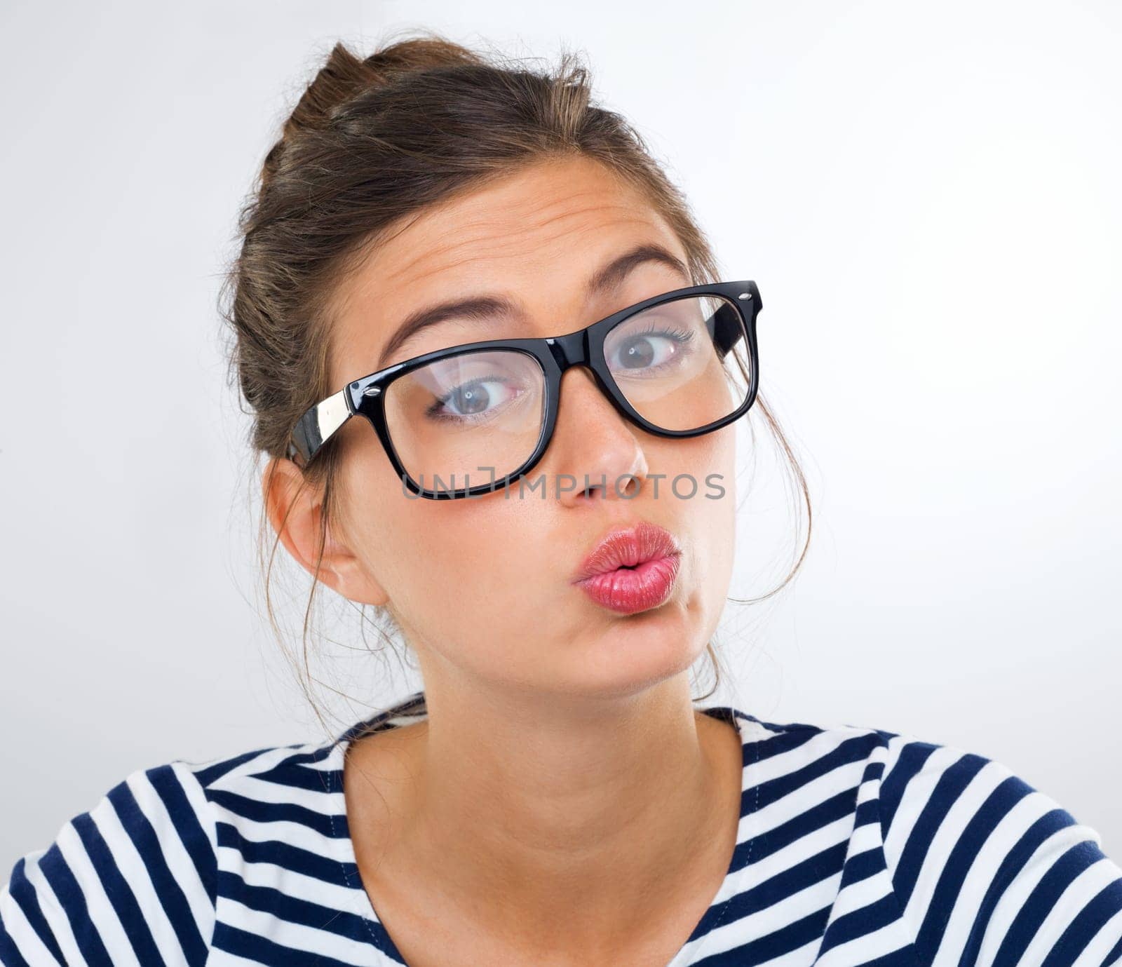 Portrait, woman and pout with glasses, student and person on a white studio background. Face, model and girl with lipstick and flirt with romance gesture and eyewear with humor and vision by YuriArcurs