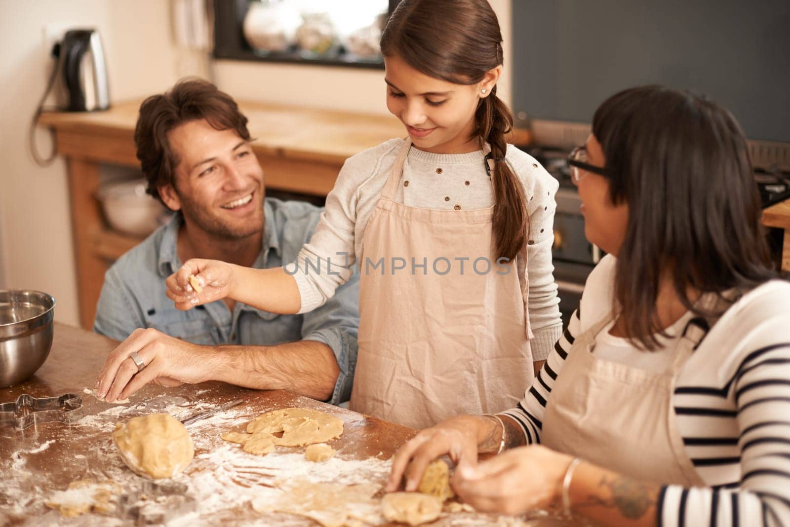 Mother, father and girl with baking in kitchen with dough, happiness and teaching with support or pride. Family, parents and child with helping, learning and bonding with cooking for dinner and hobby.