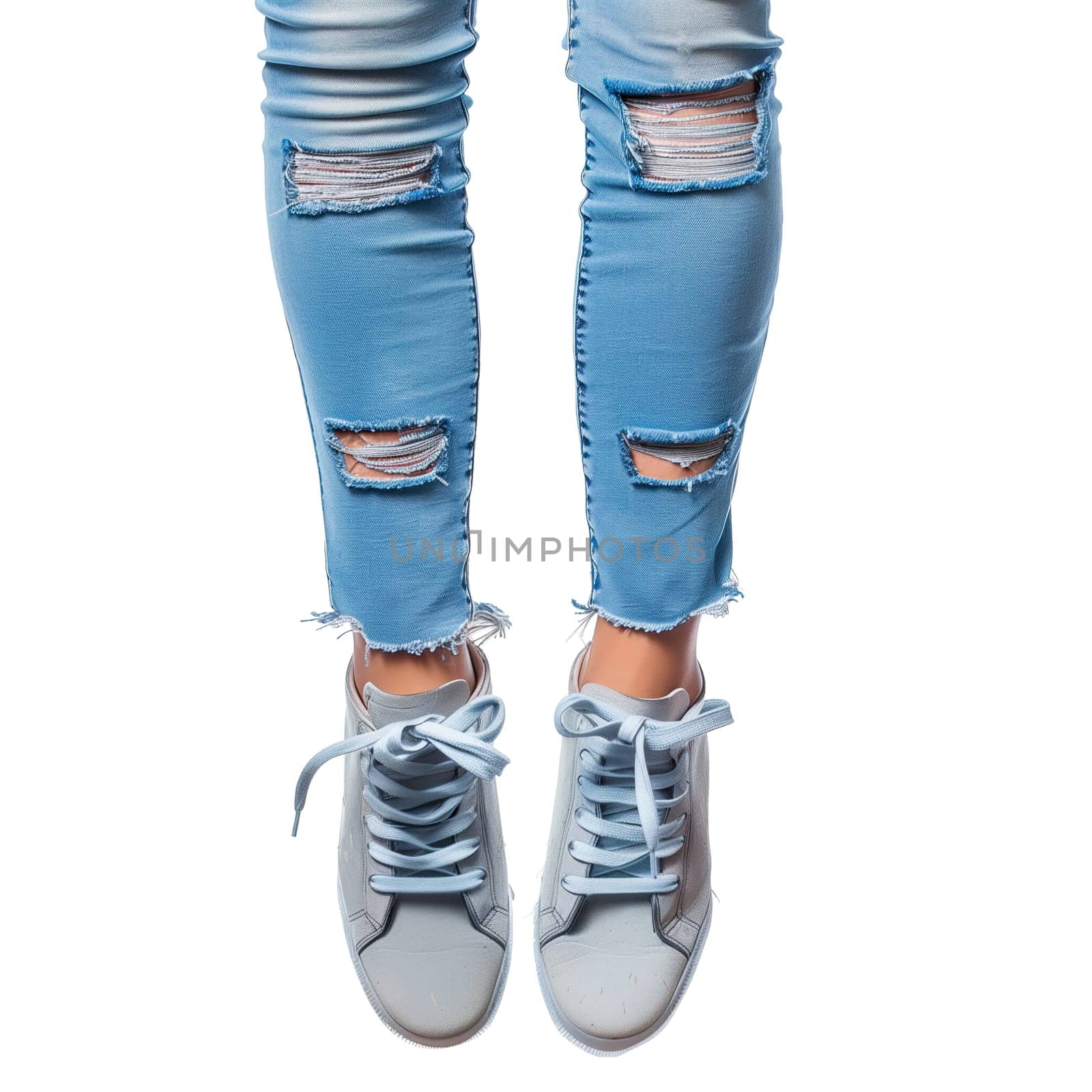 Female legs in jeans and sneakers by Dustick