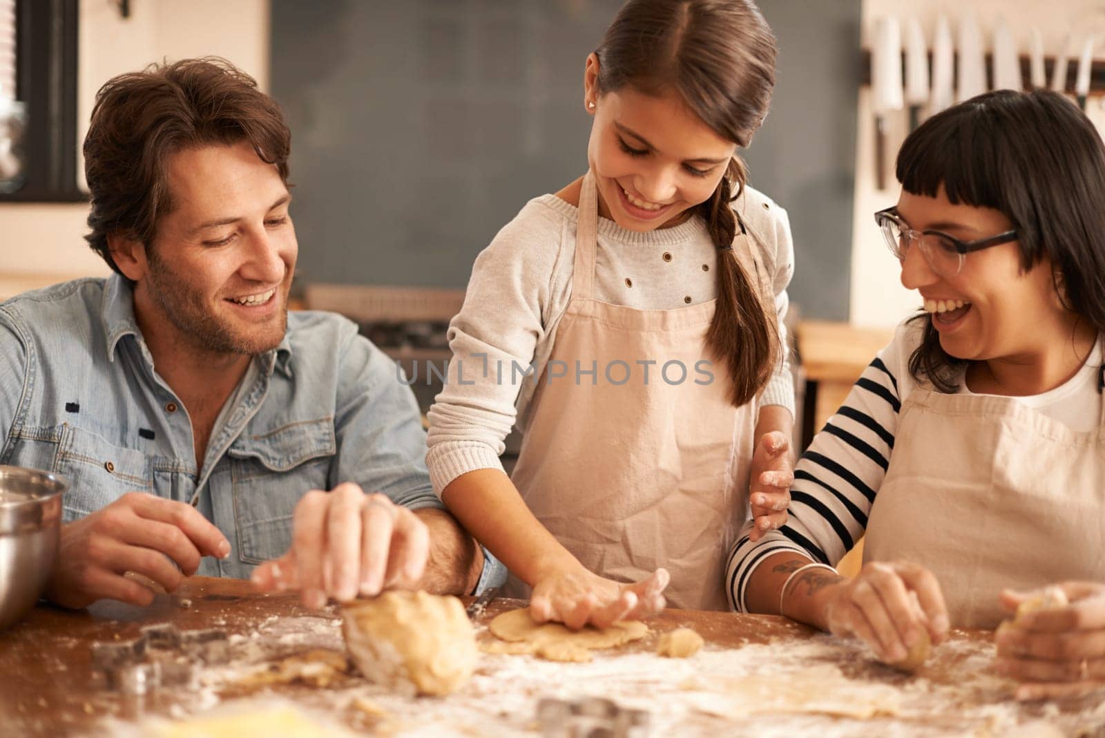 Mother, father and girl with dough for cooking in kitchen with flour, happiness and teaching with support. Family, parents and child with helping, learning and bonding with baking for snack and hobby.