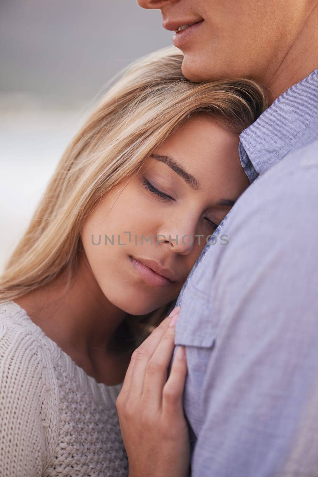 Couple, relax and hug for love by water, ocean waves and peace for romance in relationship. People, closeup and commitment in marriage, embrace and travel on vacation or holiday for outdoor date.