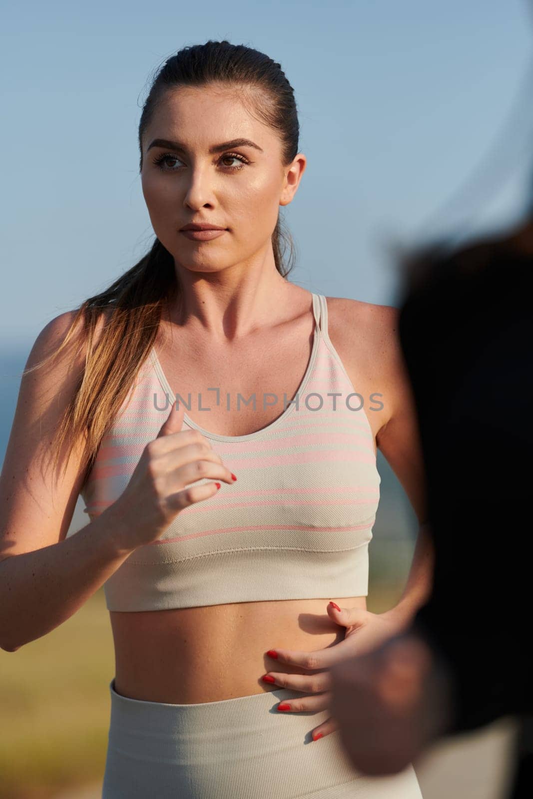 A determined woman athlete trains for success in the morning sun. by dotshock