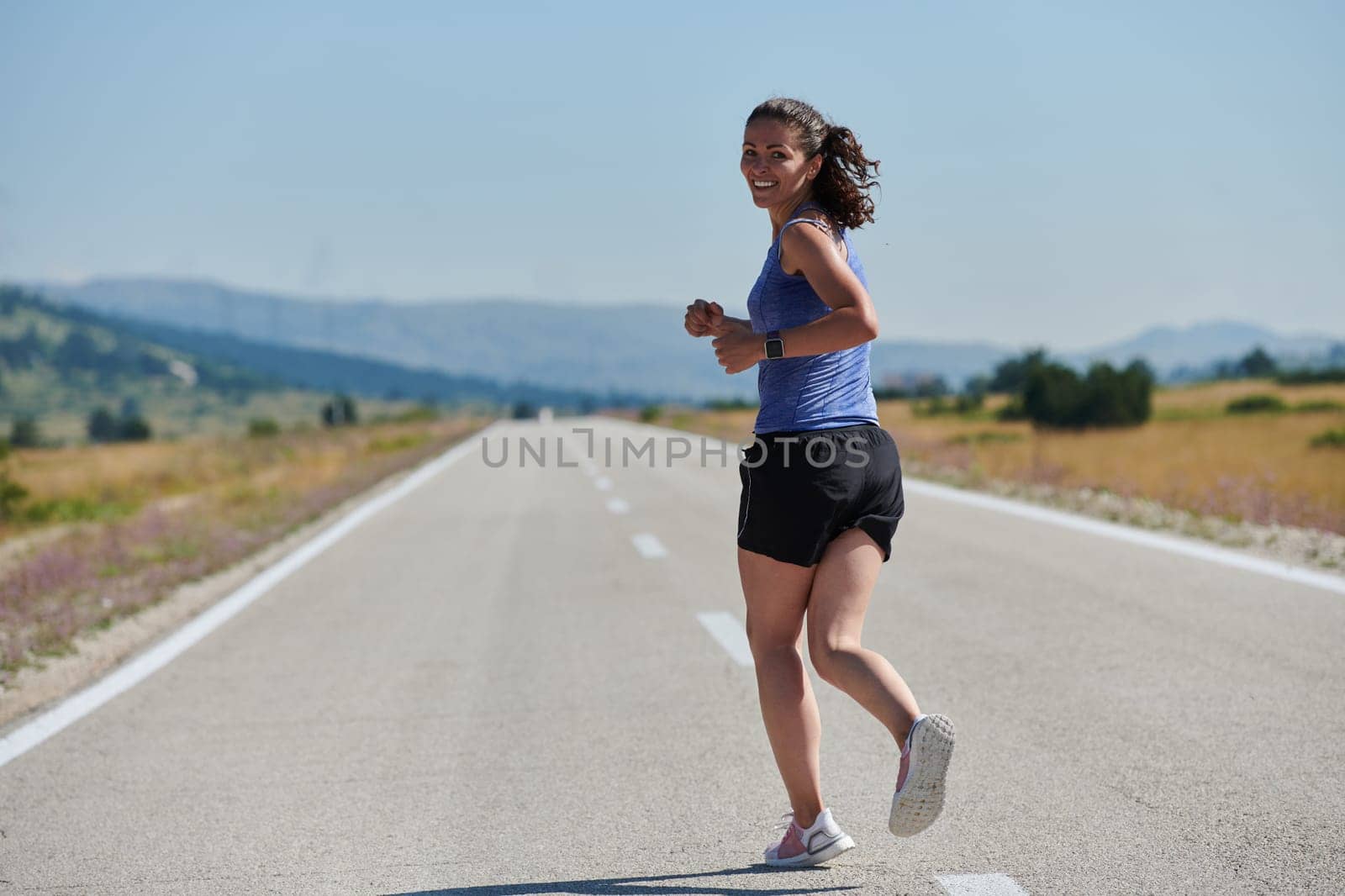 A determined woman athlete trains for success in the morning sun. by dotshock