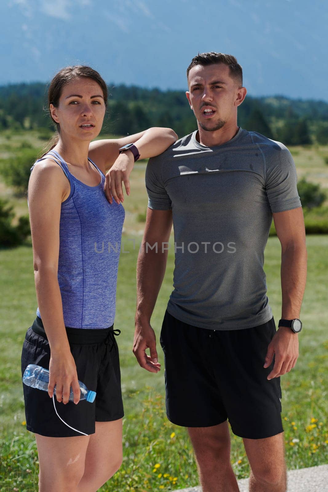 In a serene moment of post-run tranquility, a romantic couple rests together, embodying both exhaustion and affection after a rigorous training session.