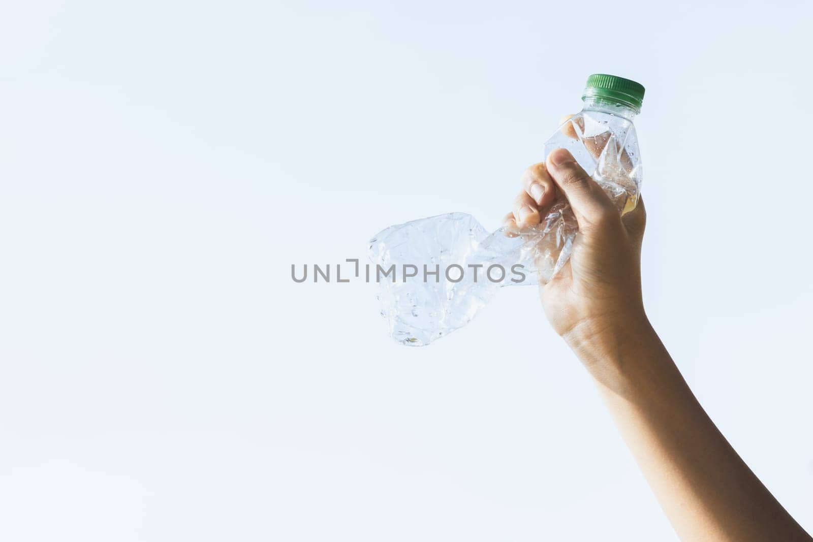 Recyclable can waste held in hand up on sky isolated background. Gyre by biancoblue