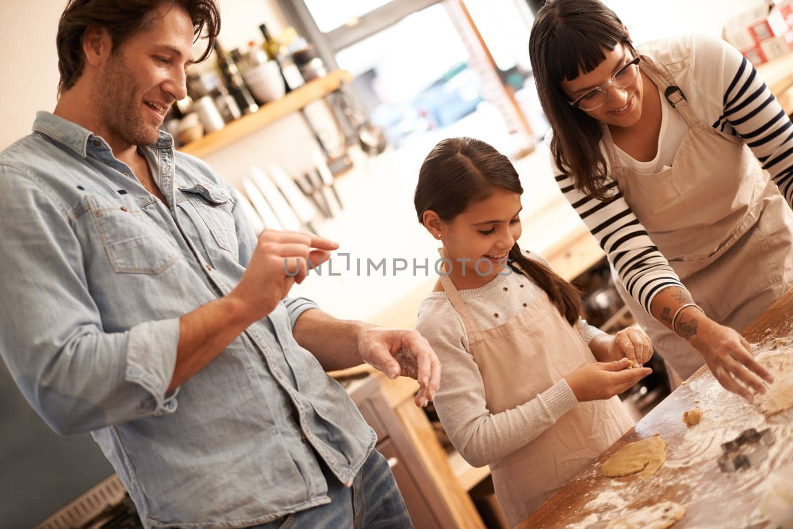 Mother, father and girl with baking dough in kitchen with flour, happiness and teaching with support. Family, parents and child with helping, learning and bonding with cooking for hobby and snack.