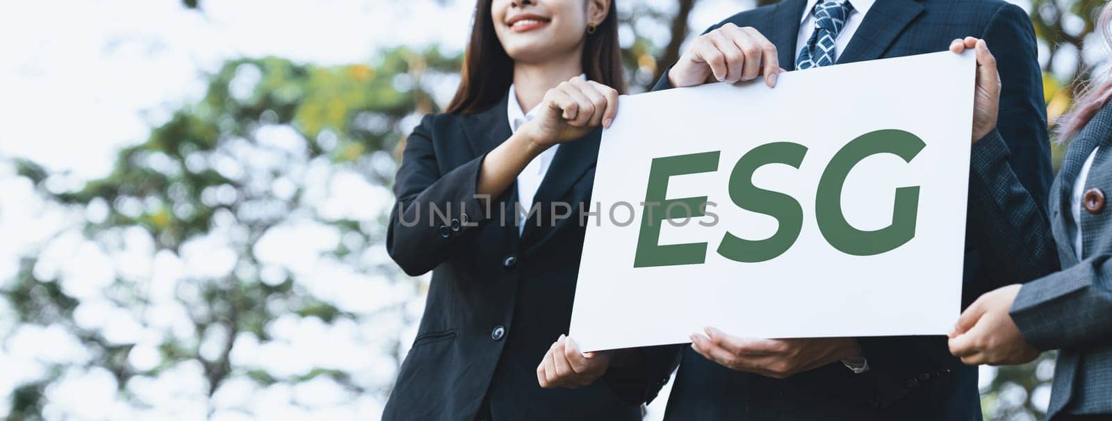 Group of business people stand united, holding eco-friendly idea and concept for environmental awareness campaign and embracing ESG principle for greener environment and sustainable future. Gyre