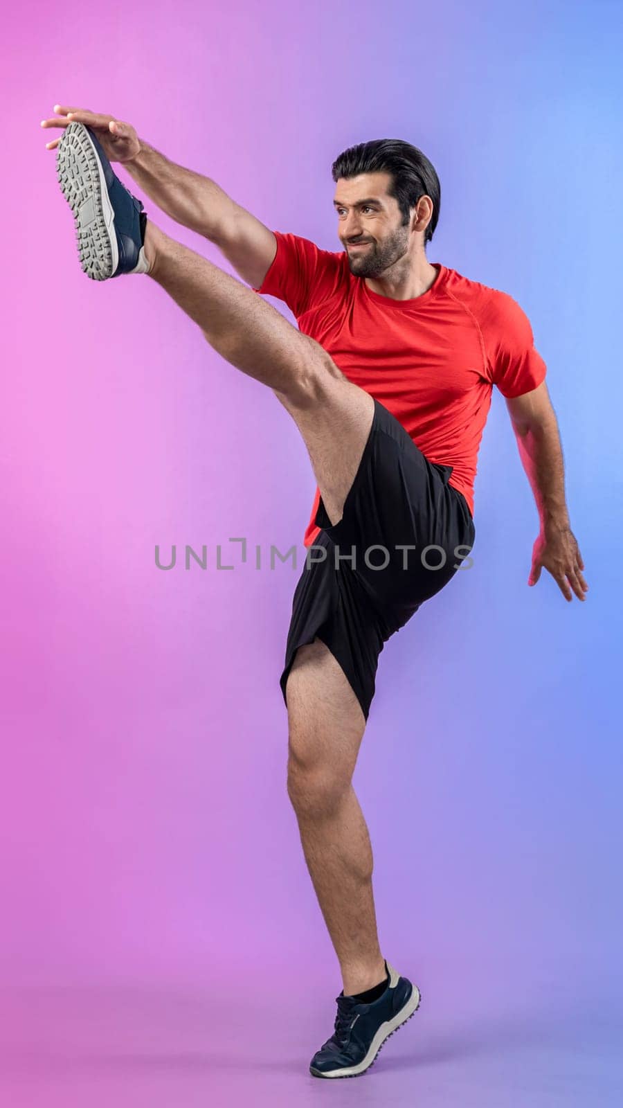Full body length gaiety shot athletic and sporty young man with fitness in cardio exercise, kicking position posture on isolated background. Healthy active and body care lifestyle.