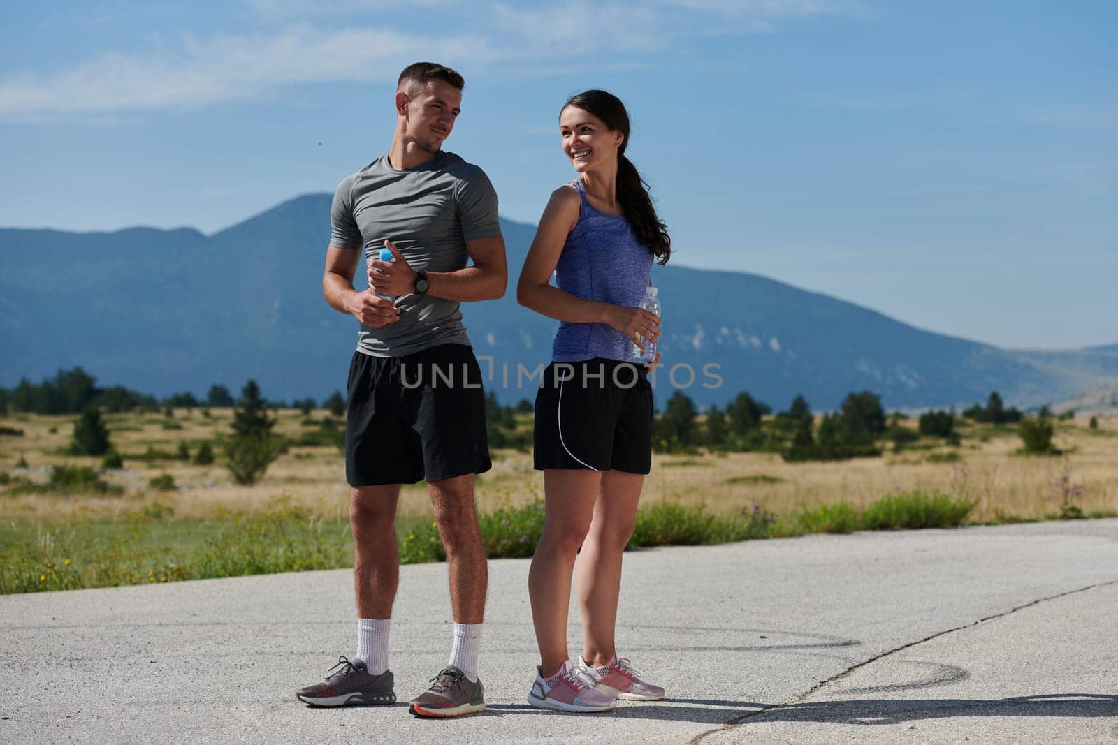 In a serene moment of post-run tranquility, a romantic couple rests together, embodying both exhaustion and affection after a rigorous training session.