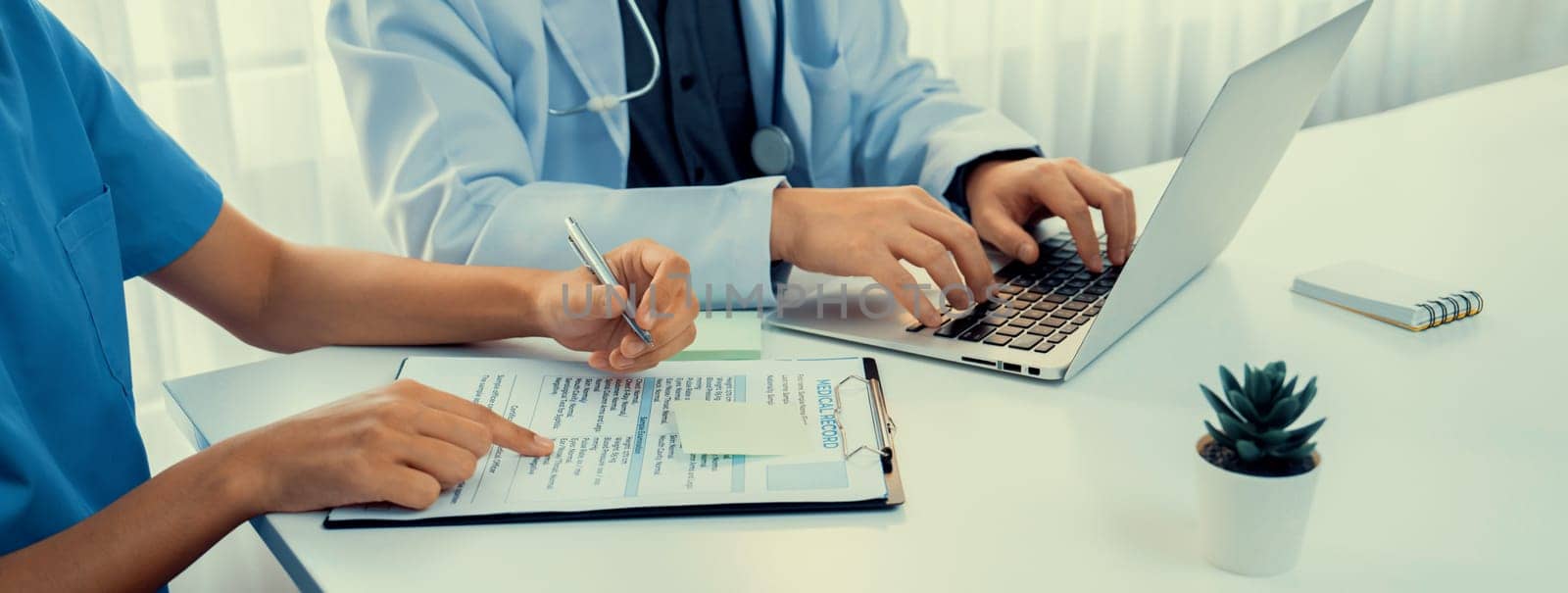 Professional various team of medical working and planning medical treatment at hospital table together. Teamwork lead to successful illness and sickness treatment. Panorama Rigid